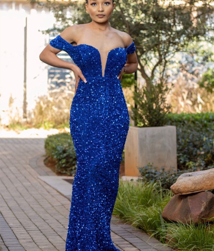 Model in a royal blue sequin off-shoulder mermaid dress